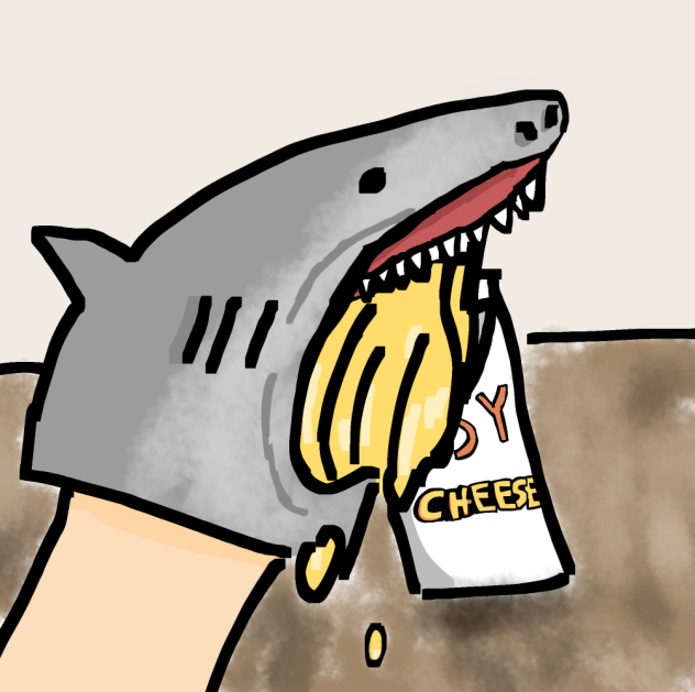 Shark puppet eating cheese